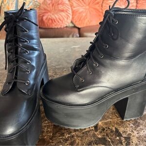 Black faux leather platform lace up boots with back zipper for easy on/off.